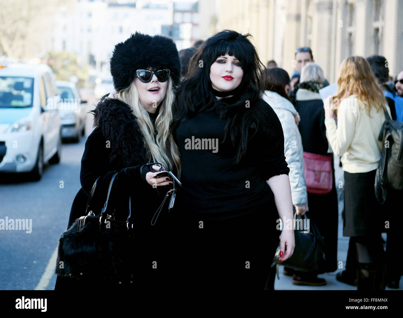 Brighton, UK. 11th February, 2016. This couple of fashionable ladies are dressed to stay warm as the weather turns colder in Brighton today as they attended the University of Brighton Graduation Ceremony held in The Dome . The forecast is for colder weather to spread across Britain with snow predicted for next week  Credit:  Simon Dack/Alamy Live News Stock Photo
