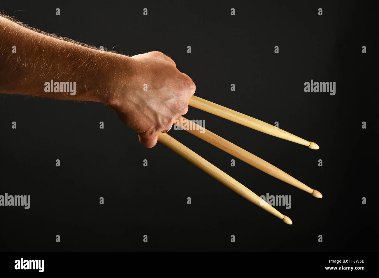 Famous wolverine claws heroic gesture, man hand holding three wooden