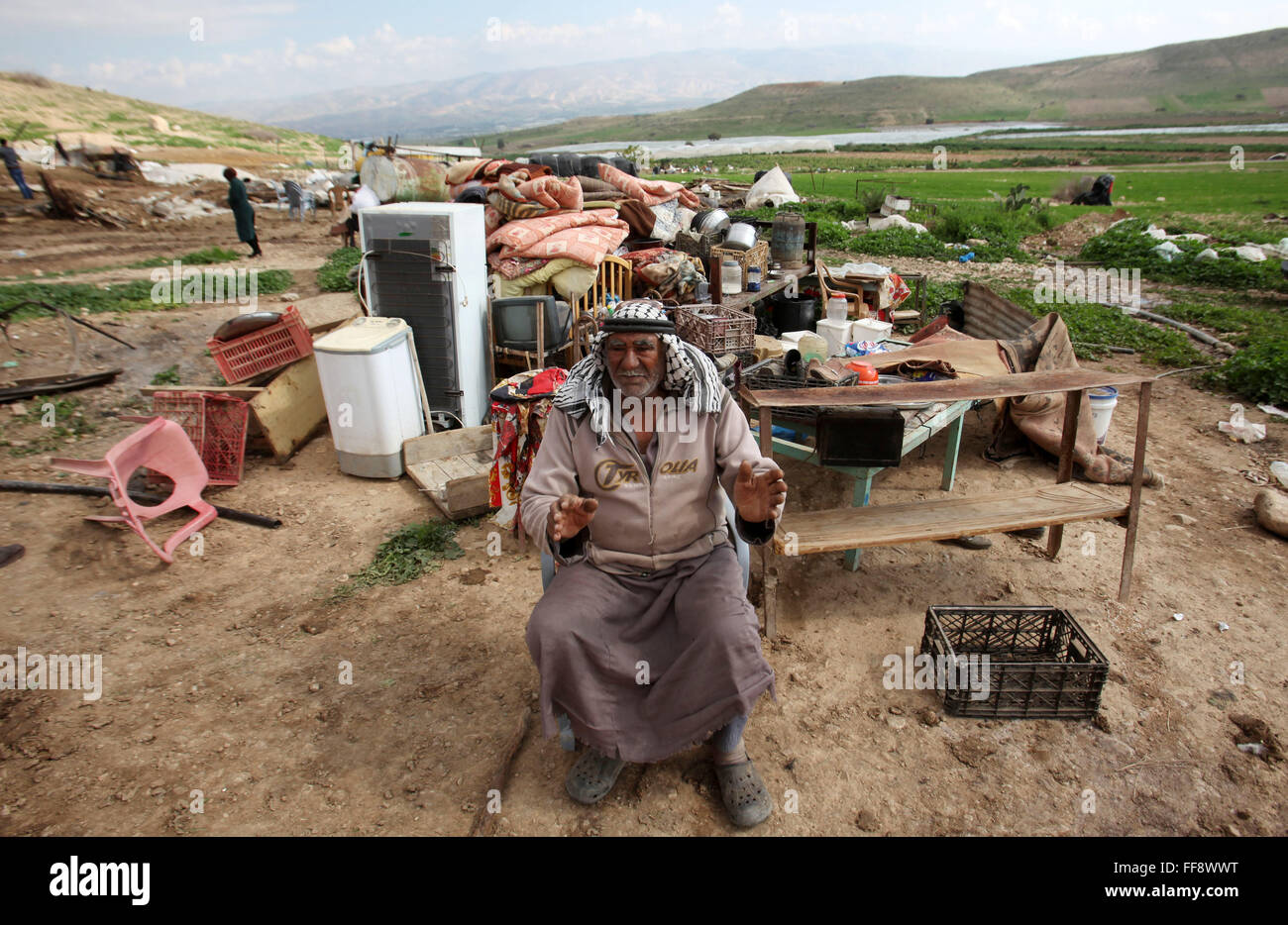 Tubas, West Bank, Palestinian Territory. 11th Feb, 2016. A Palestinian man sits on the rubble of his house that was demolished by the Israeli army, in the Jordan valley, near the West Bank town of Tubas. Israel is planning to annex the Jordan Valley into a completely Israeli area, primarily in agriculture, targeting to ban territorial contiguity between a future Palestinian state and the rest of the Arab world © Nedal Eshtayah/APA Images/ZUMA Wire/Alamy Live News Stock Photo