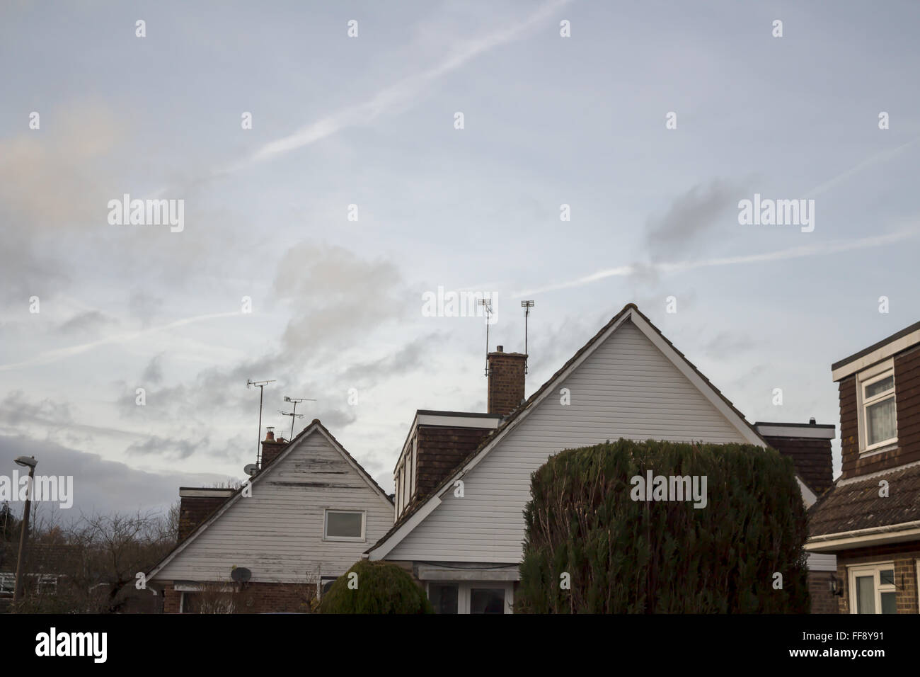 Houses in against cloudy sky Stock Photo