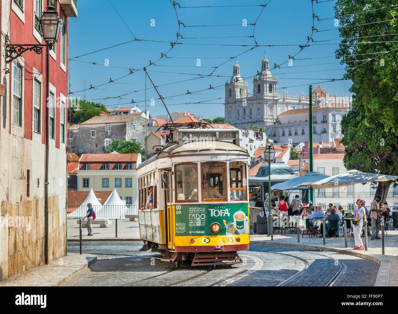 Tram 28 at Largo das Portas do Sol, with Sao Vicente de Fora Church in the background, Lisbon, Portugal Stock Photo