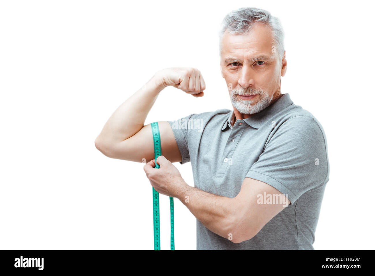 Image of muscular man measure his biceps with measuring tape in  centimeters. Isolated on white backgound Stock Photo by ©Chetty 96260608