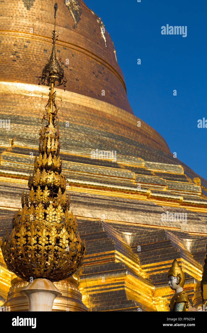 The gold encrusted paya of Shwedagon pagoda glistens in the early morning sun in Yangon. Stock Photo