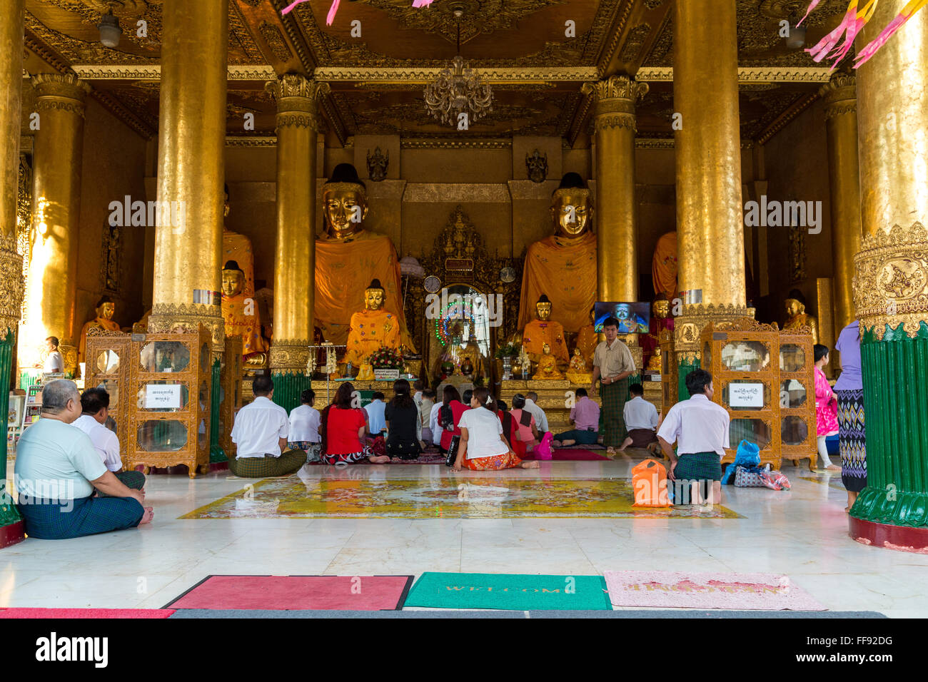 Yangon, Myanmar, 9th November 2015: The Shwedagon pagoda in Yangon is a very active temple where many people gather every day to Stock Photo