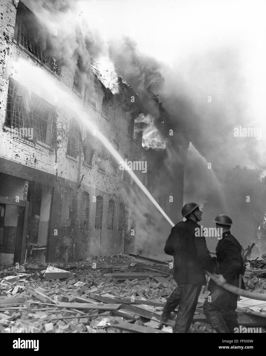 WWII: LONDON BLITZ, 1944. /nFiremen fight flames at Regency Place and Rutherford Street, London, following a German plane attack in 1944. Stock Photo