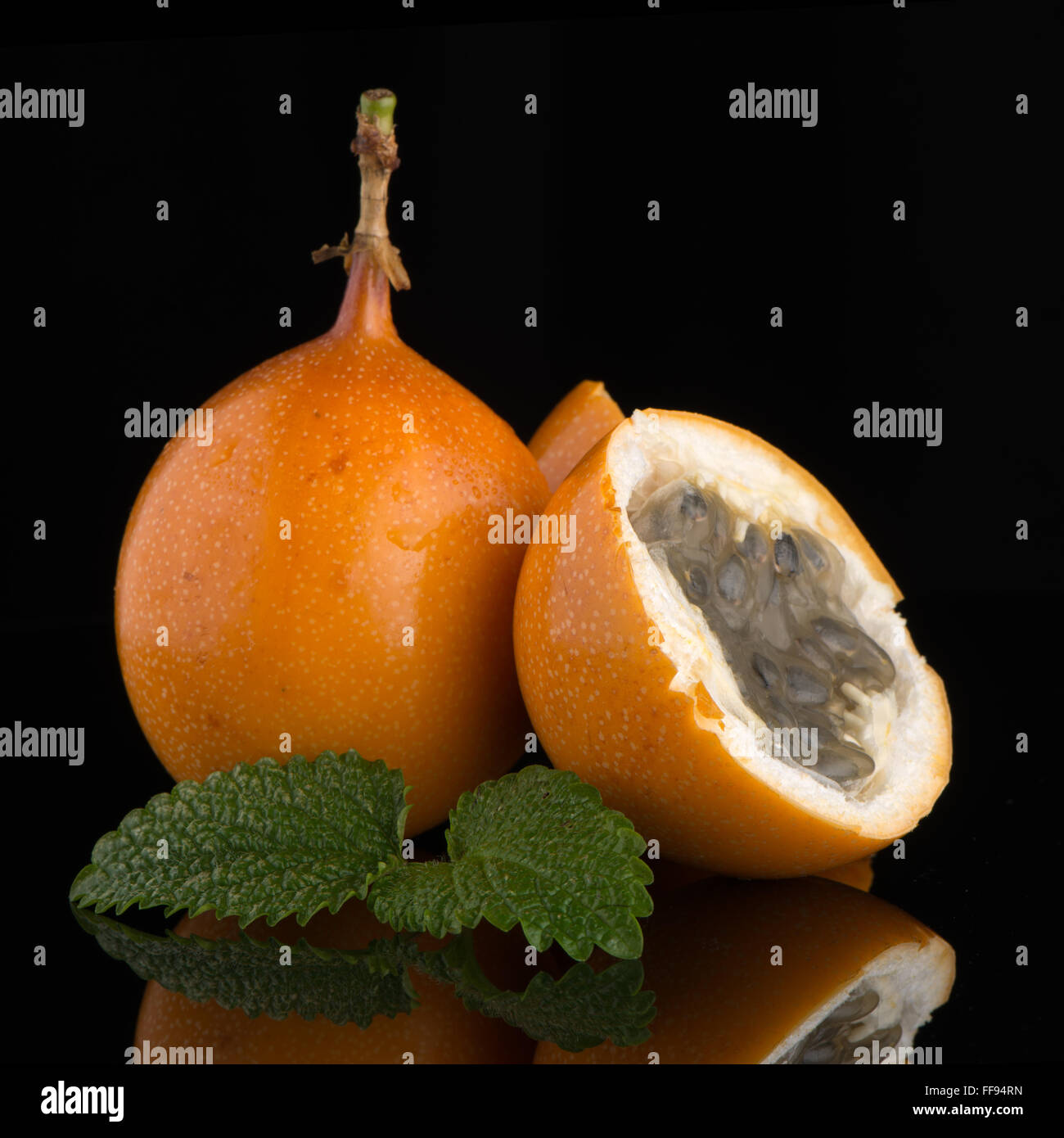 Passion fruit maracuja granadilla on black background Stock Photo - Alamy