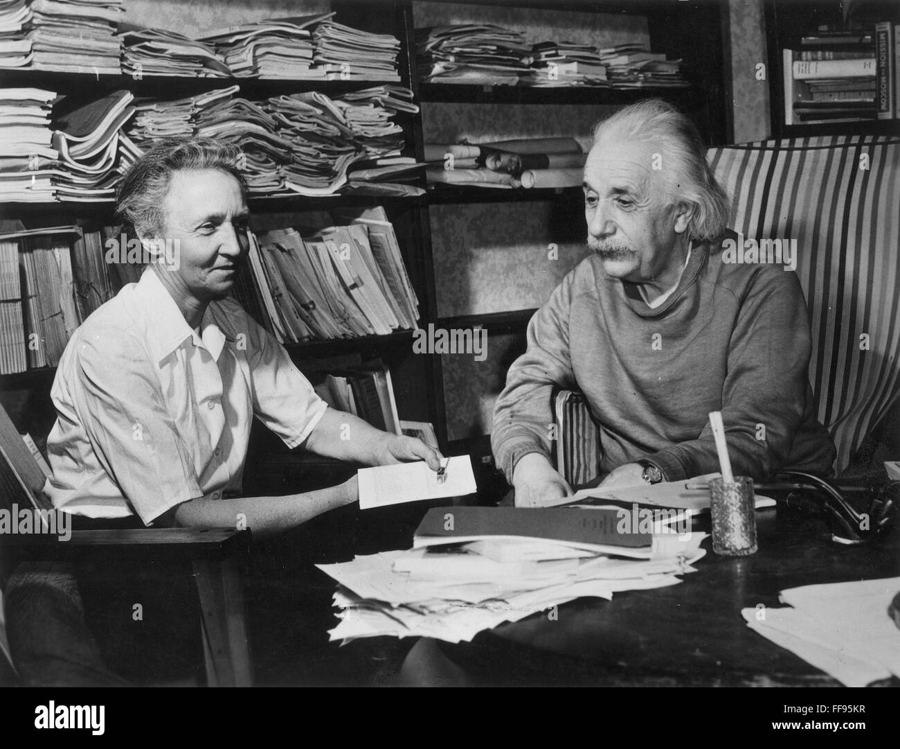 JOLIOT-CURIE/EINSTEIN. /nIrene Joliot-Curie (1897-1956), French physicist, with Albert Einstein (1879-1955), American (German born) theoretical physicist, in the study of Einstein's home in Princeton, New Jersey. Stock Photo