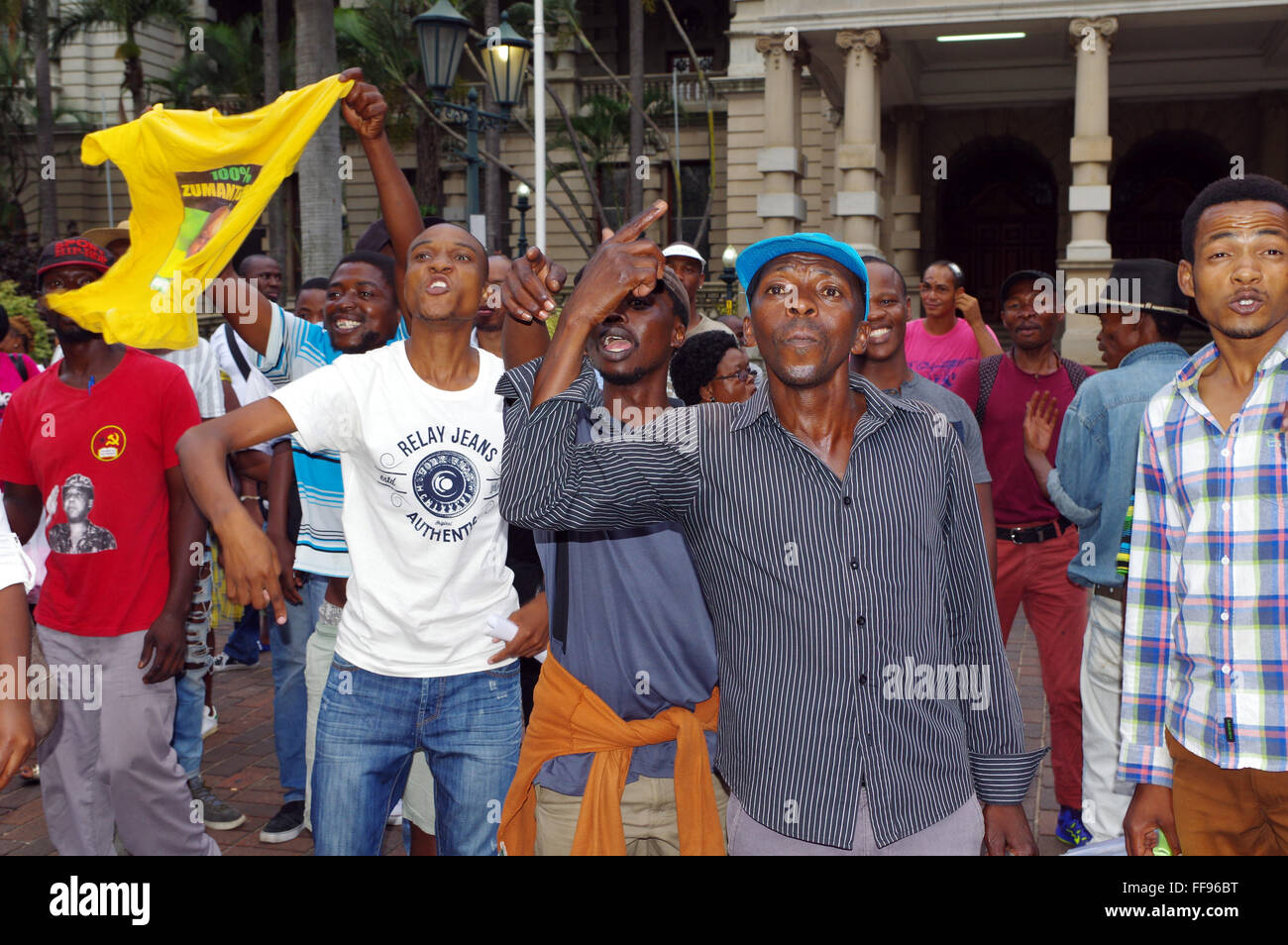 Durban, South Africa. 11th February, 2016. ON the very day that South Affrica's President Jacob Zuma was due to deliver the state of the nation address to parliament 2000 kilometres away in Cape Town, a small group of protesters staged a protest for him to go. Passing supporters of the South African president heckled those who want him to leave office and made their displeasure at the attack on their icon clear. Credit:  Giordano Stolley/Alamy Live News Stock Photo