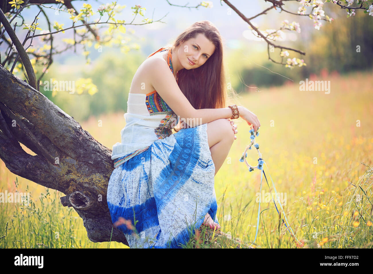 Smiling beautiful woman in soft spring light . Hippie and gypsy dress Stock Photo