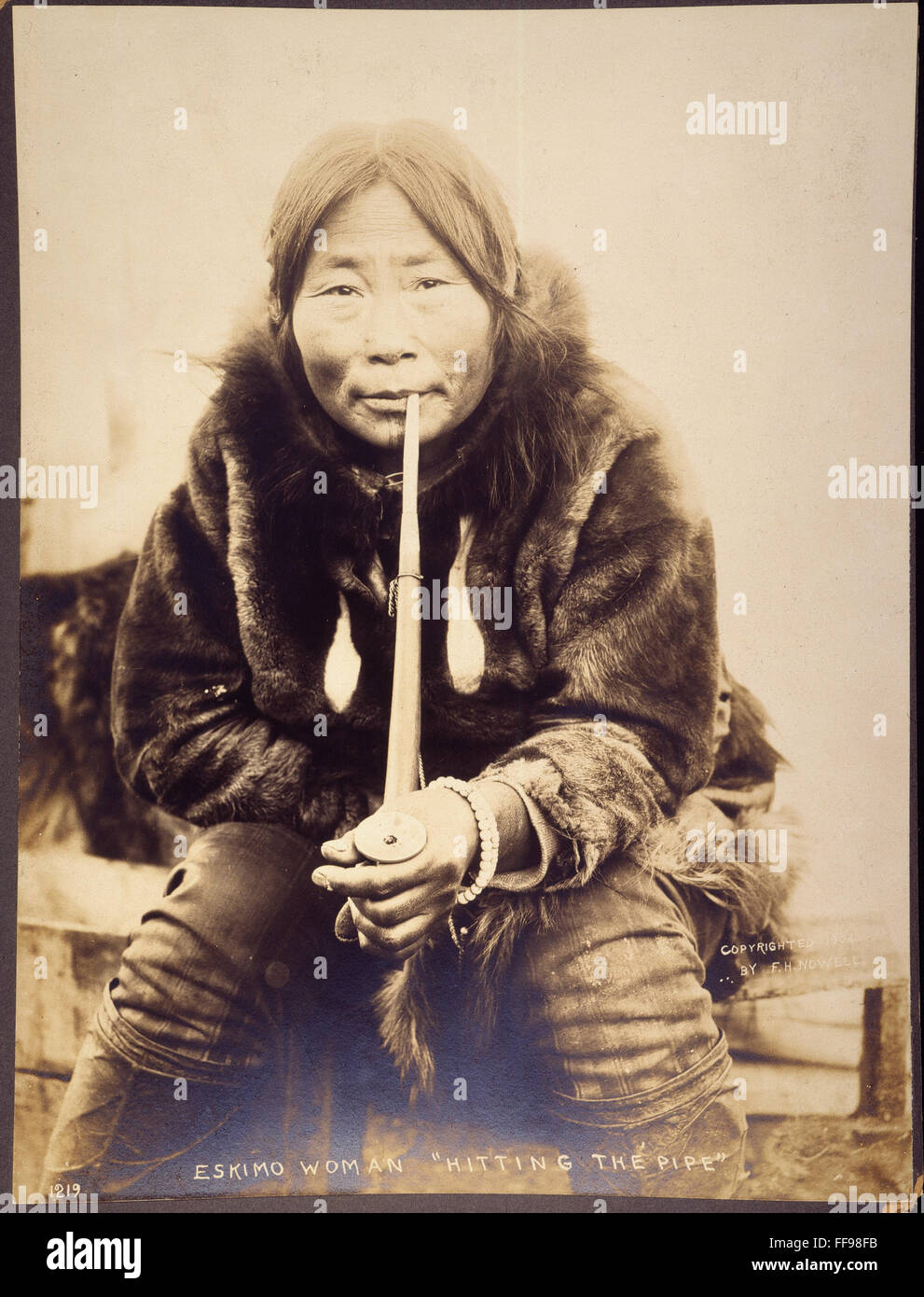 ALASKA: ESKIMO WOMAN, 1904. /nAn Eskimo woman smoking a pipe ...