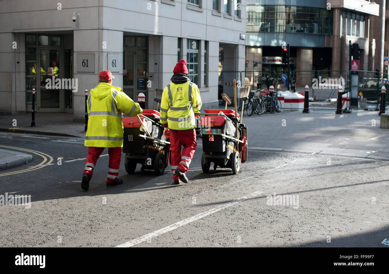 Street sweepers pushing carts City of London cleaner Stock Photo Alamy