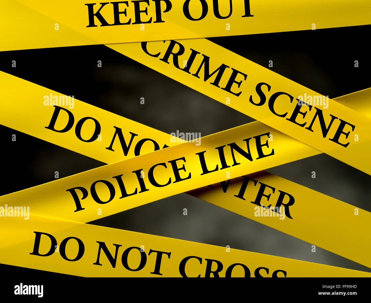 Crime area restricted by several yellow police line tapes Stock Photo