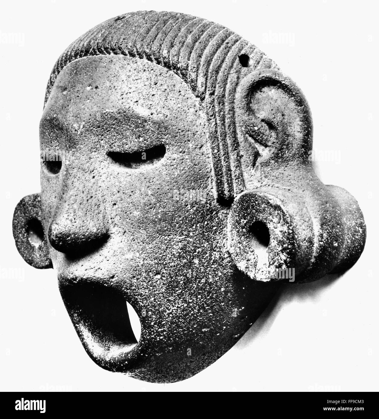 AZTEC MASK, 14th CENTURY. /nStone mask representing the flayed god Xipe Totec, whose priests used to array in the skins of sacrificial victims as a symbol of Aztec, Mexico, probably