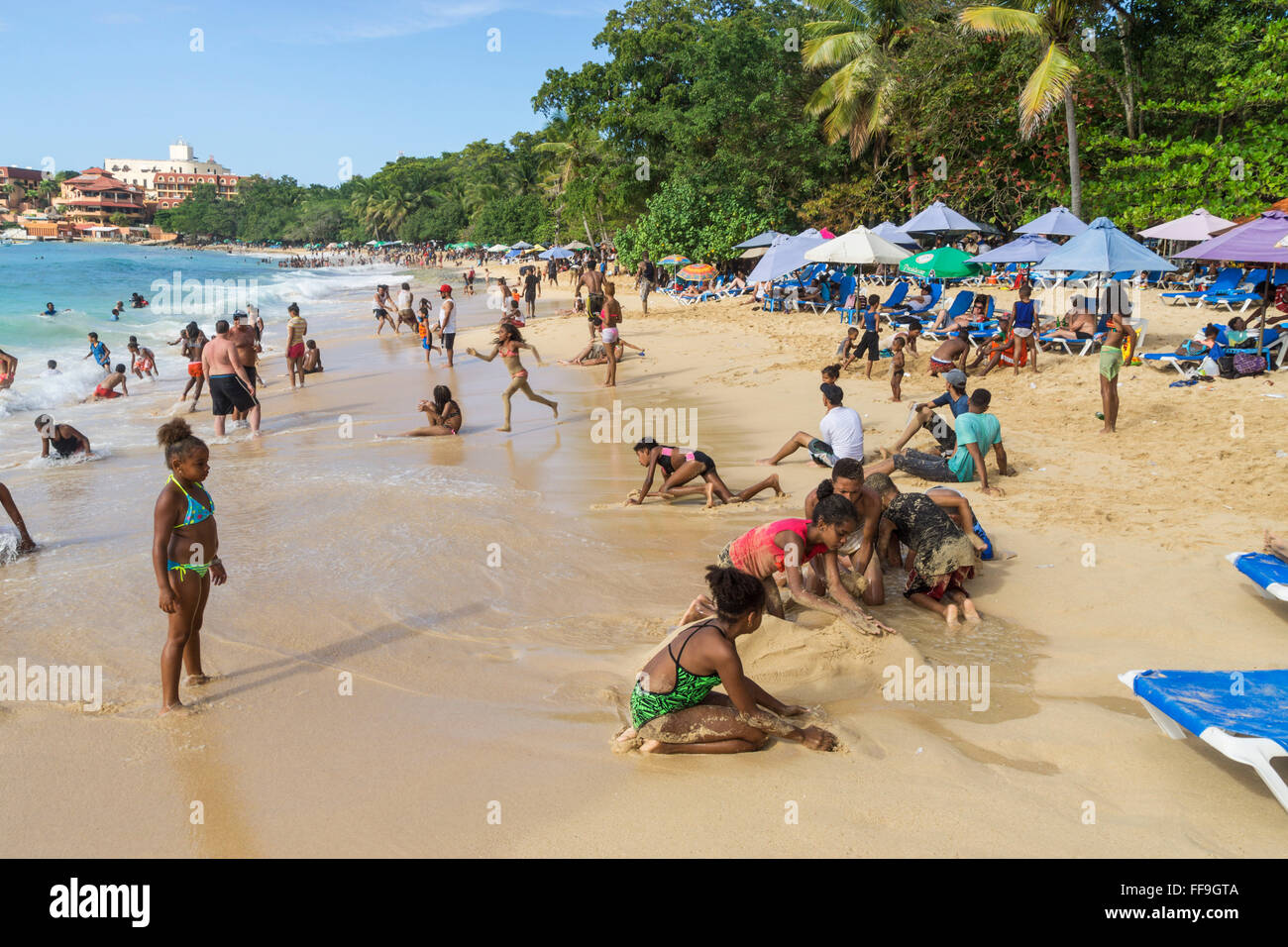 Local people at Sosua beach , kids,  Sosua, , Puaerto Plata,  Dominican Republic Stock Photo