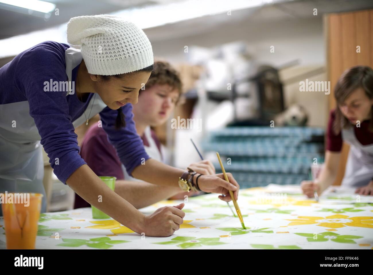 Community members help fill in the decorative elements of what will become parts of a mural outside a North-Philadelphia mosque. Stock Photo