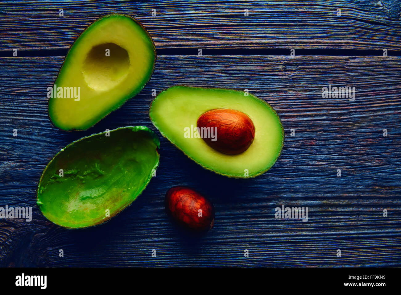 avocado cut on aged wood table board cutted half Stock Photo - Alamy