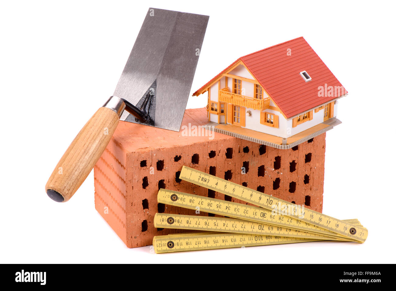 brick for house construction and tool with model house Stock Photo