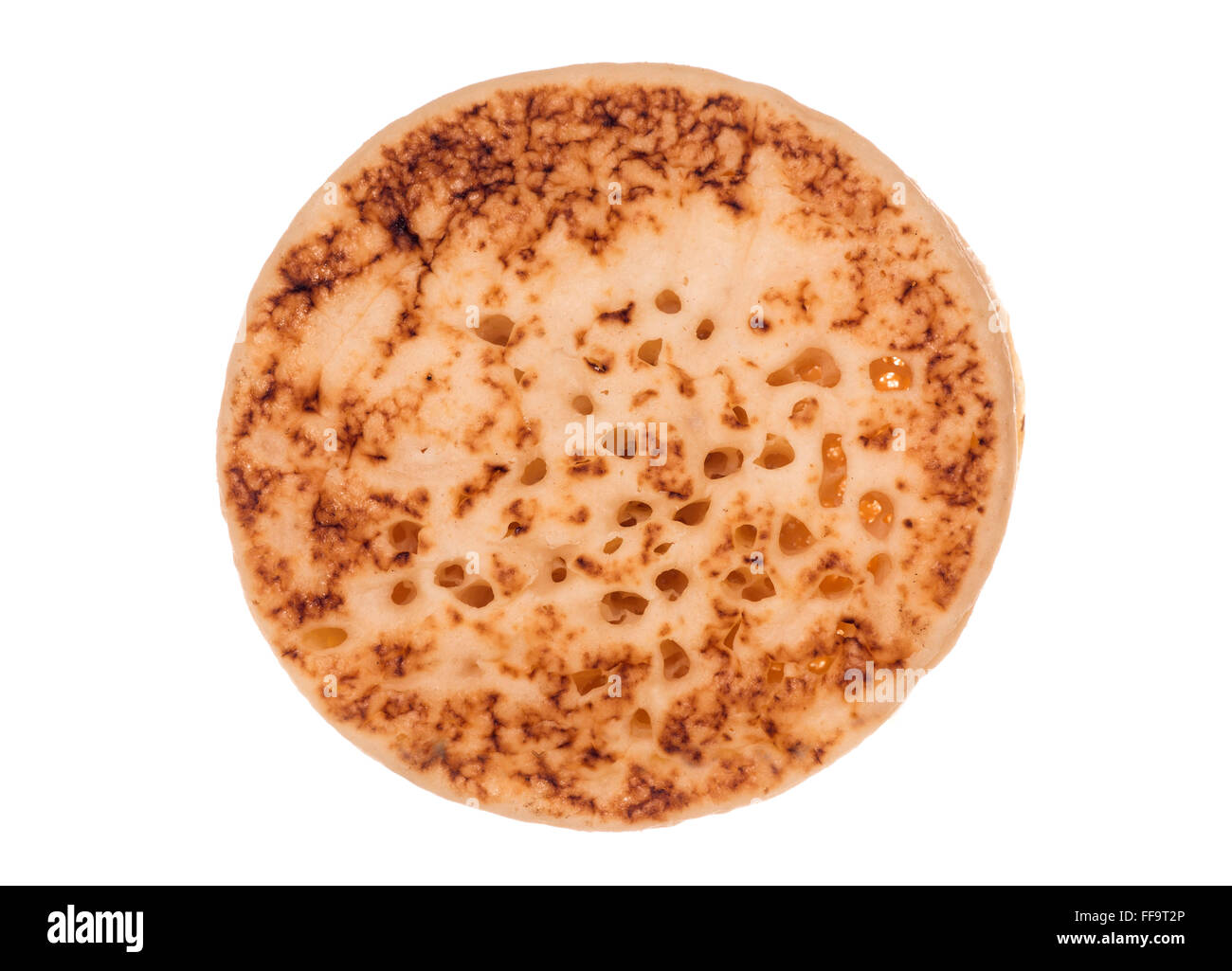 Single crumpet isolated on white background Stock Photo