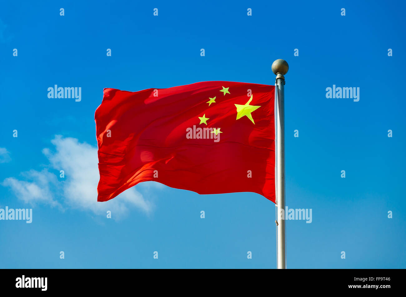 Chinese national flag with blue sky as background Stock Photo