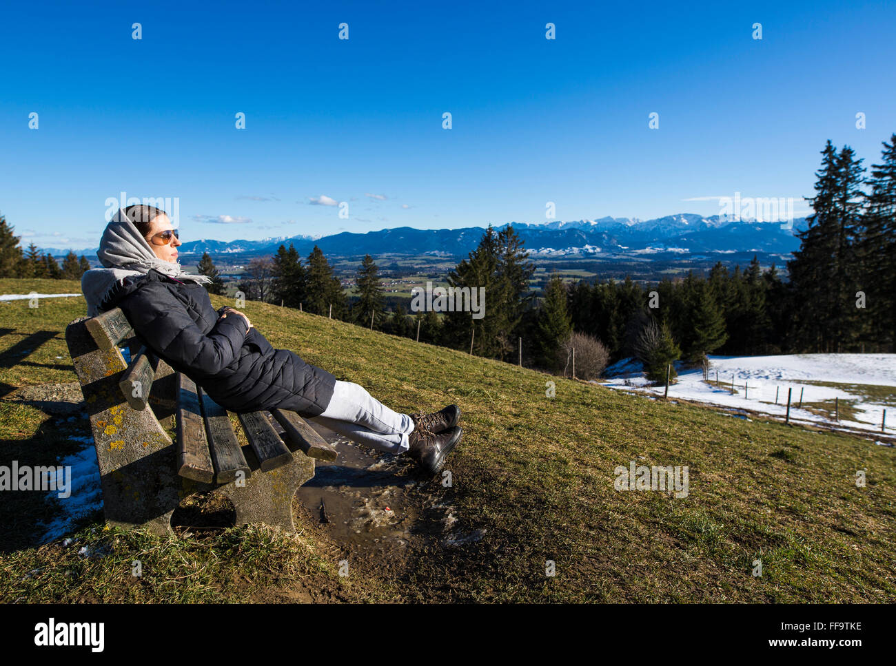 Rettenbach, Germany. 11th February, 2016. Woman enjoys the panoramic view of the bavarian alpes from the mountain Auerberg on January 11, 2016 in Rettenbach, Germany.  Credit:  Peter Schatz / Alamy Live News Stock Photo