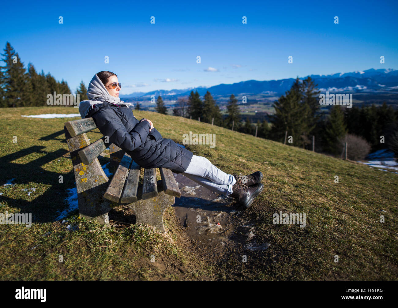 Rettenbach, Germany. 11th February, 2016. Woman enjoys the panoramic view of the bavarian alps from the mountain Auerberg on January 11, 2016 in Rettenbach, Germany.  Credit:  Peter Schatz / Alamy Live News Stock Photo