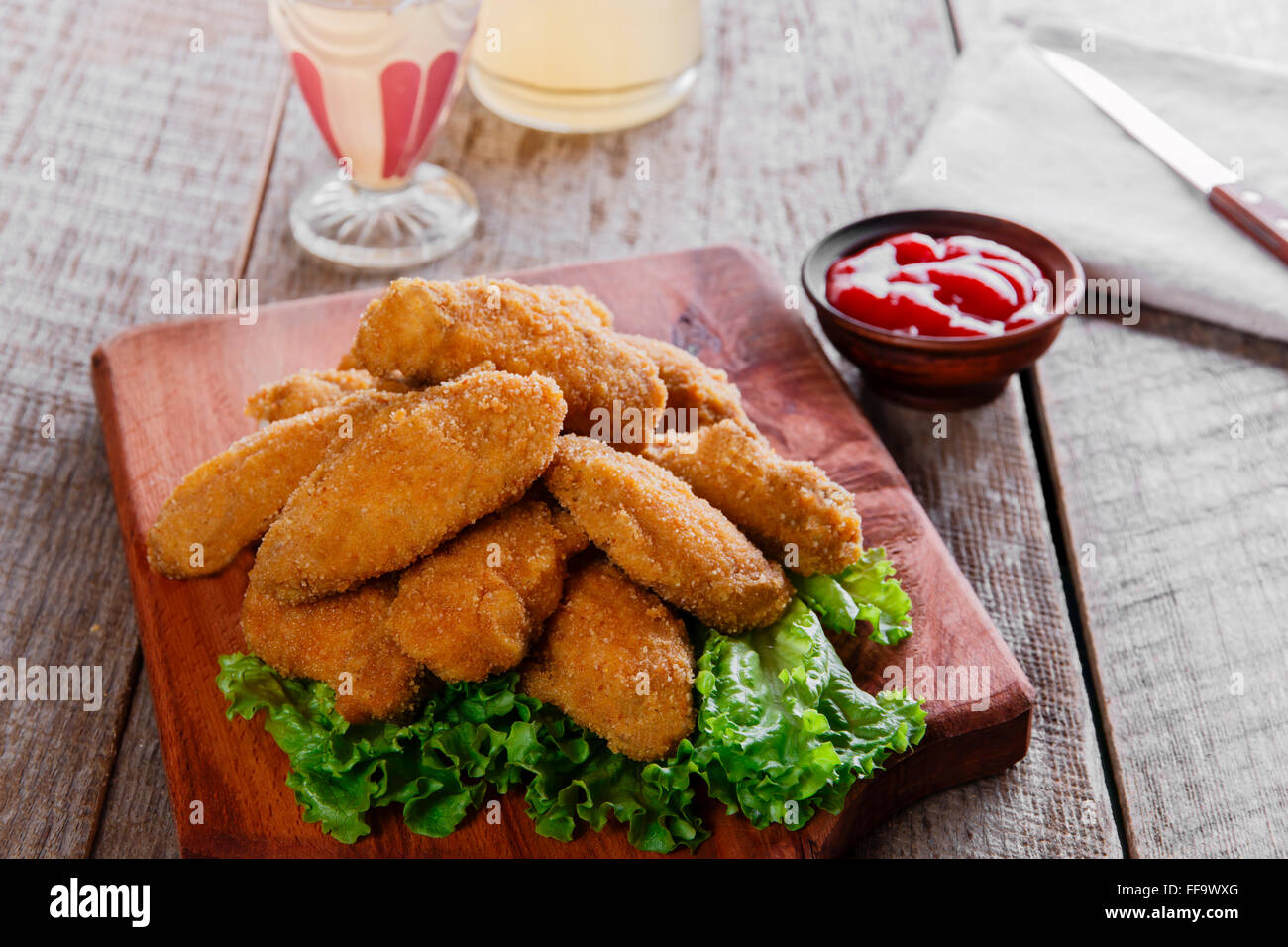 chicken wings fried in breadcrumbs with sauce Stock Photo