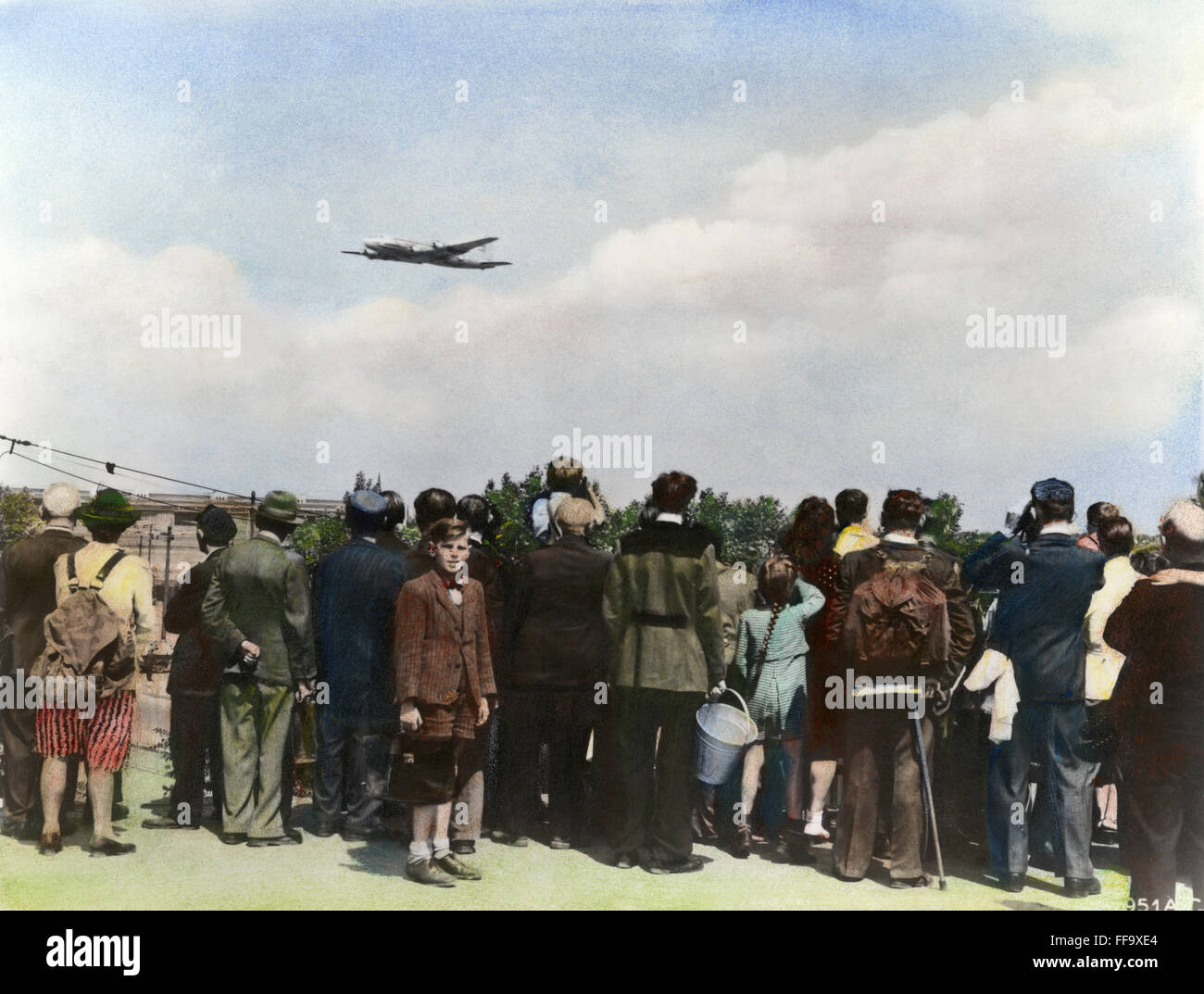 BERLIN AIRLIFT, 1948. /nBerliners watching the arrival and departure of Allied airlift freighters at Templehof Air Base 3 months after the beginning of the Soviet blockade of Berlin on 1 April 1948. Oil over a photograph. Stock Photo