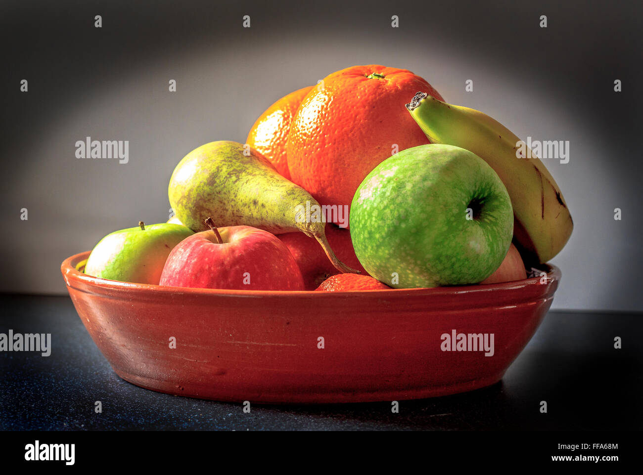Fruit bowl naturally lit in Renaissance, Rembrandt, style. Stock Photo