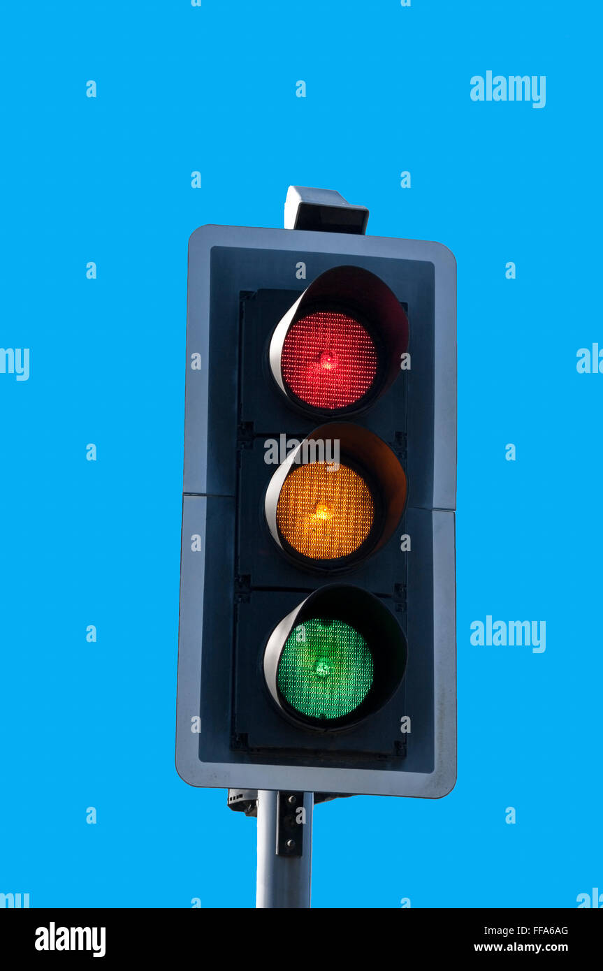 Red, amber and green traffic lights all on together against blue sky  background Stock Photo - Alamy