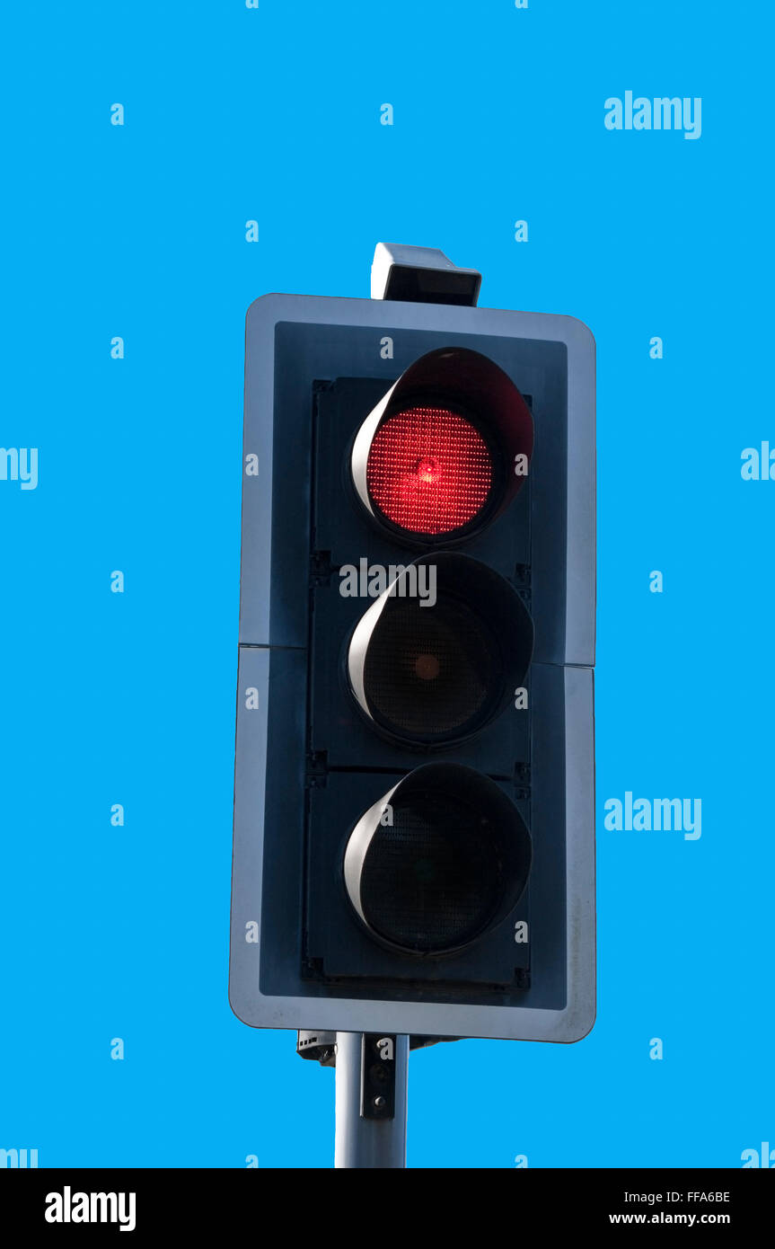 Red traffic light against blue sky background. Stock Photo
