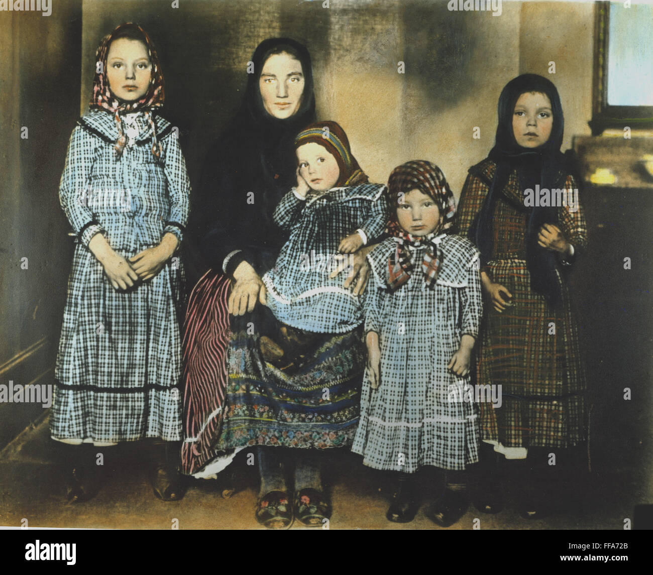 IMMIGRANT MOTHER, c1900. /nA mother and her children at Ellis Island. Oil over a photograph. Stock Photo
