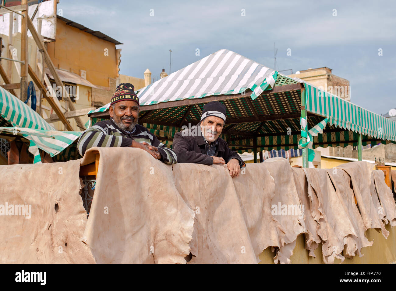 Laborers working in Chouwara leather tannery in the Fes El Bali Medina. Fez, Morocco. Stock Photo