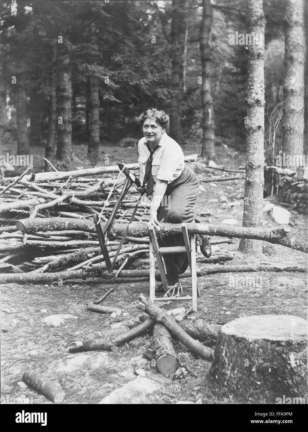 OLIVE FREMSTAD (1872-1951)./nAmerican (Swedish born) operatic soprano. Cutting wood at her Bridgton, Maine, home in 1913. Stock Photo