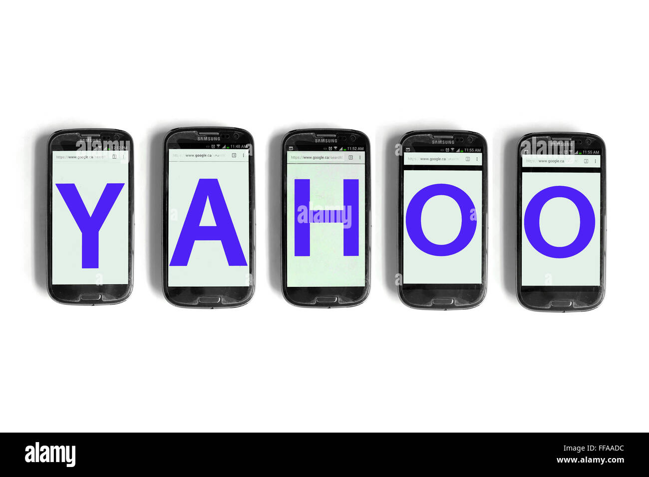 Yahoo on the screens of smartphones photographed against a white ...