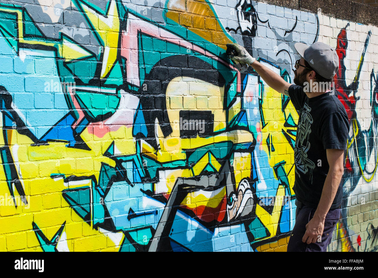 Street art in Shoreditch. Urban artist drawing graffiti on a wall in Shoreditch Stock Photo Alamy