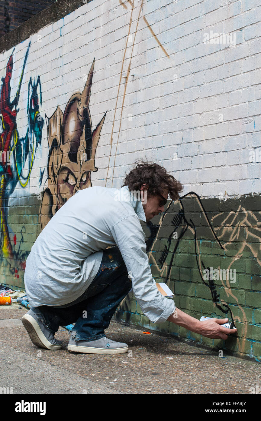 Street art in Shoreditch. Urban artist drawing graffiti on a wall in Shoreditch Stock Photo Alamy