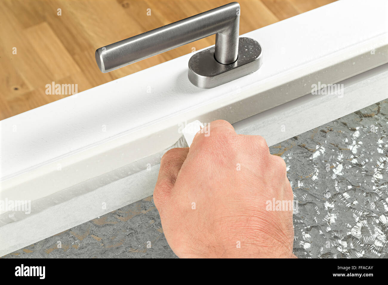renewing of a silicone joint on a window Stock Photo
