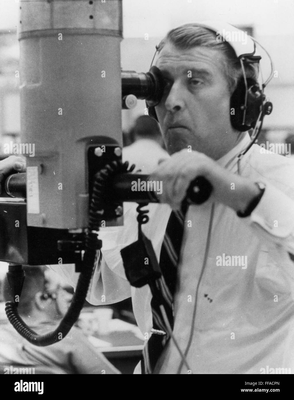 WERNHER von BRAUN /n(1912-1977). German rocket engineer. Observing the successful launch of the satellite Saturn I through a persicope at Cape Kennedy, Florida, 29 January 1964. Stock Photo