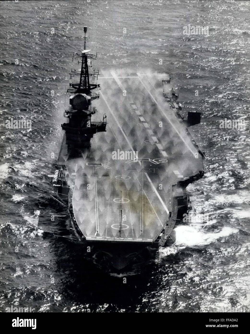 1974 - In case of fall out fire sprinkler on boat deck Following her long refit H.M.S. Hermes, now equipped to carry the latest strike, fighter, anti-submarine and airborne early warning Naval aircraft, prepares for her third General Service Commission. This picturesque shot of the carrier during work-up shows the array of water jets during a pre-wetting operation, the system of spraying exterior surfaces to free them of the affects of nuclear fall out. Her main anti-aircraft weapon is now the short range sea to air guided missile Seacat. © Keystone Pictures USA/ZUMAPRESS.com/Alamy Live News Stock Photo