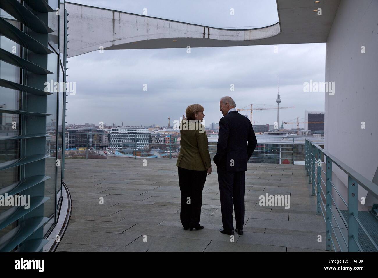 German Chancellor Angela Merkel shows U.S Vice President Joe Biden the Berlin skyline from the balcony outside her office February 1, 2013 in Berlin, Germany. Stock Photo