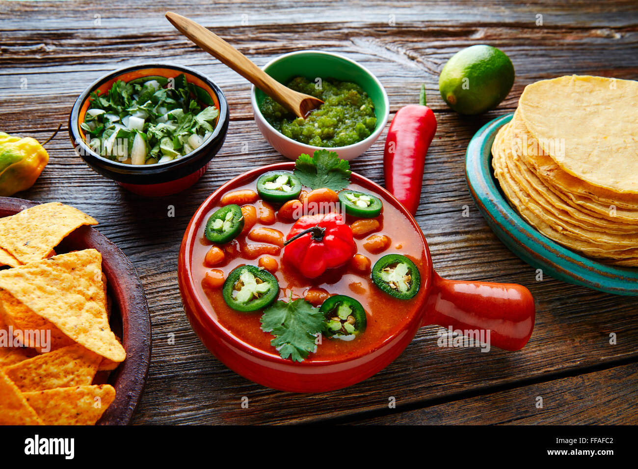 Frijoles charros mexican beans with chili pepper sides and tortillas Stock Photo