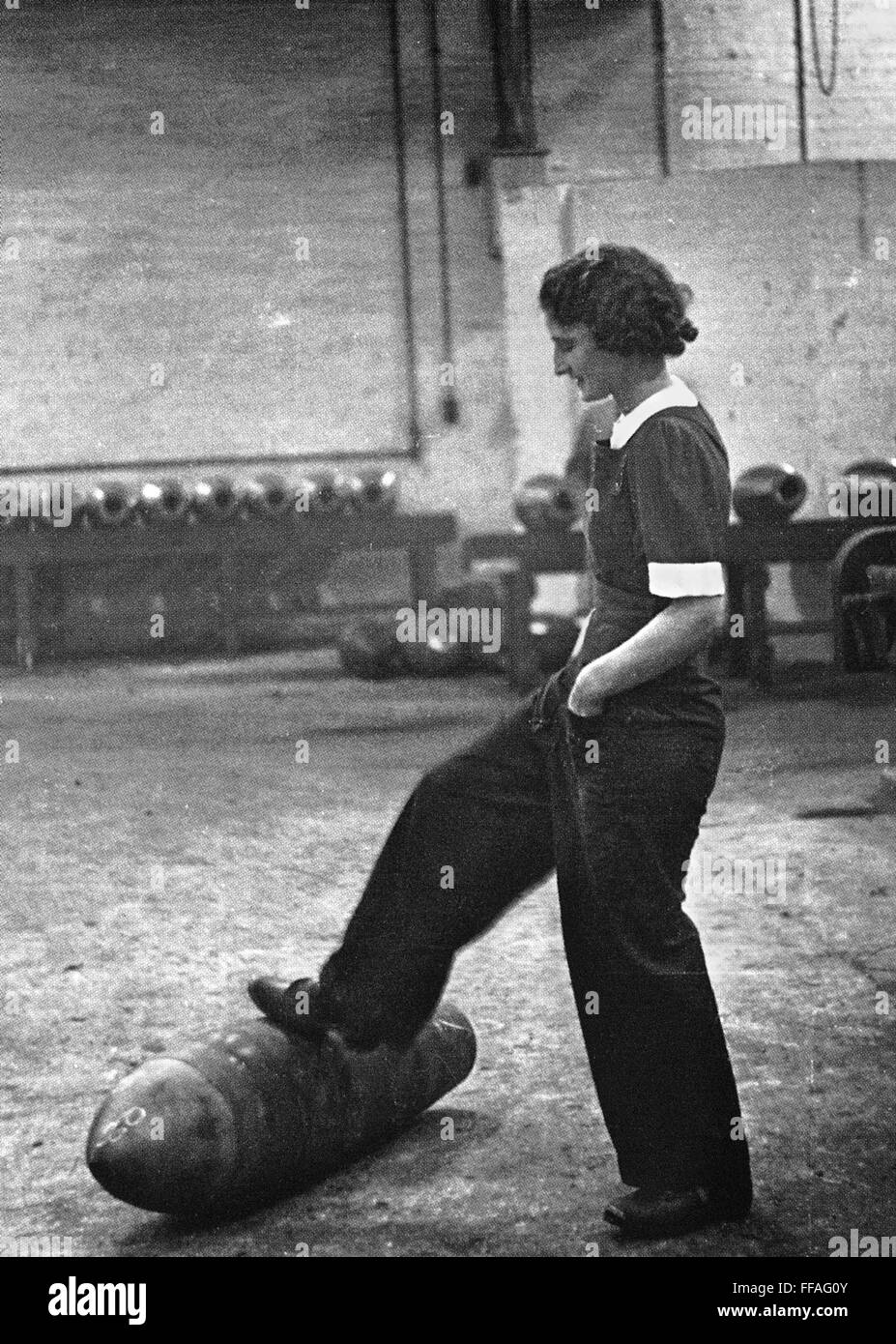 Wwii Munitions Worker Na Female Worker Rolls Out A Bomb With Her Foot At A British Munitions 