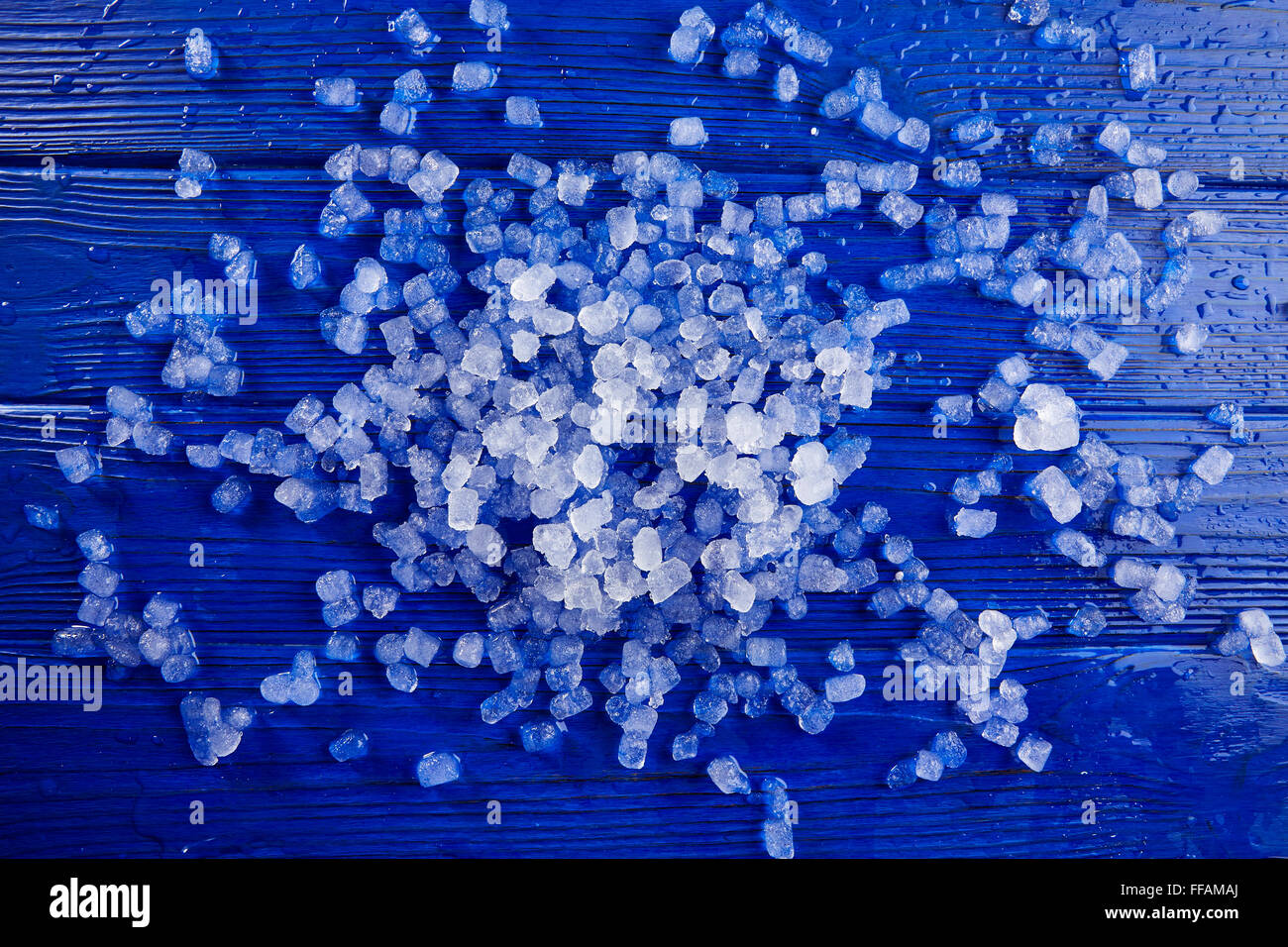 little ice cubes over blue wood background Stock Photo Alamy