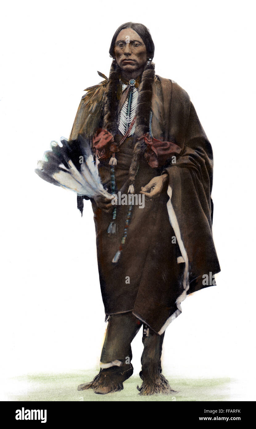 QUANAH PARKER (1845?-1911). /nNative American Kwahadi Comanche leader. Holding an eagle-feather fan and dressed in traditional chiefly regalia. Oil over a photograph, c1890. Stock Photo