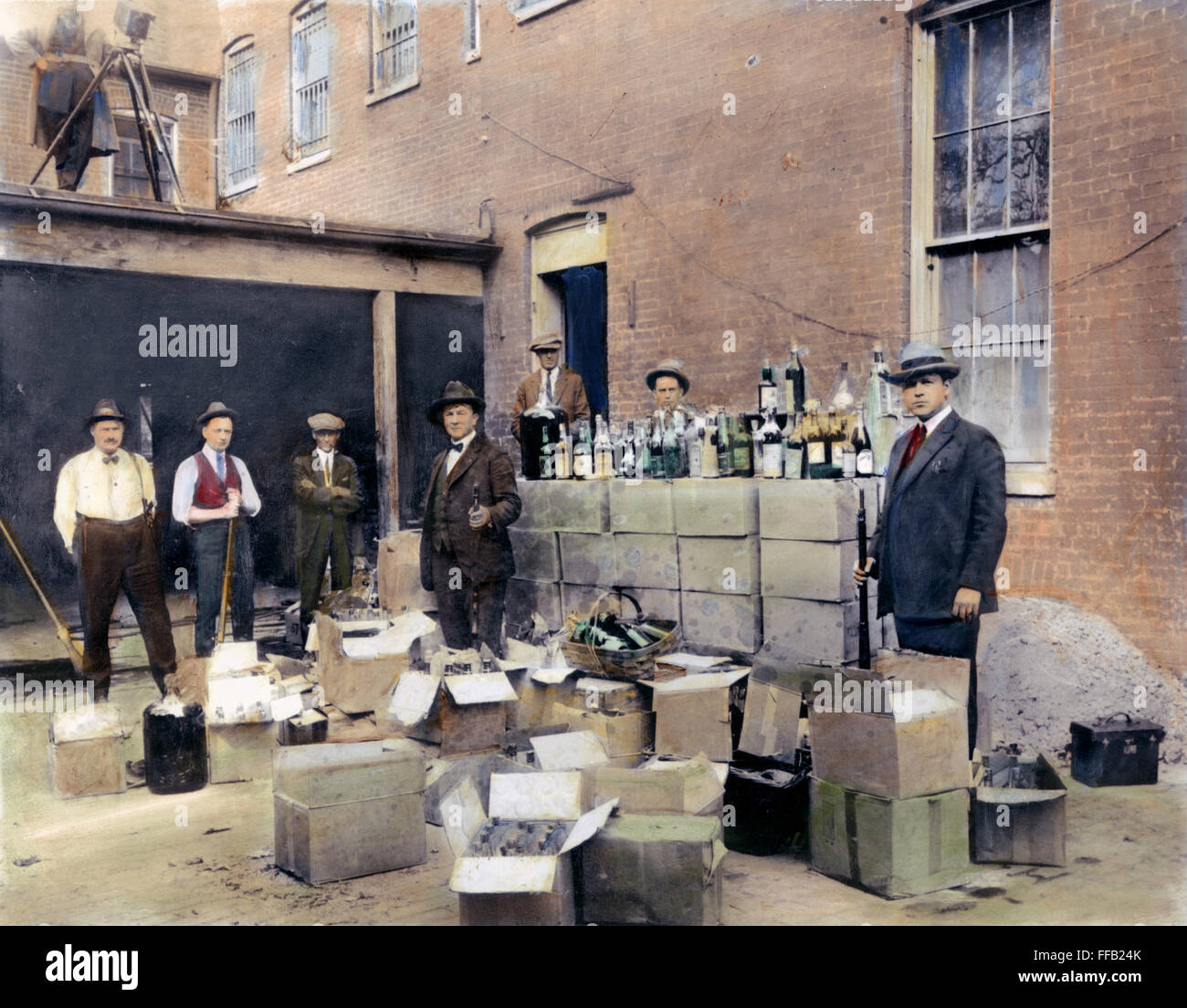 PROHIBITION, 1922. /nRevenue agents with confiscated bootleg liquor at Washington, D.C. Oil over a photograph, 1922. Stock Photo