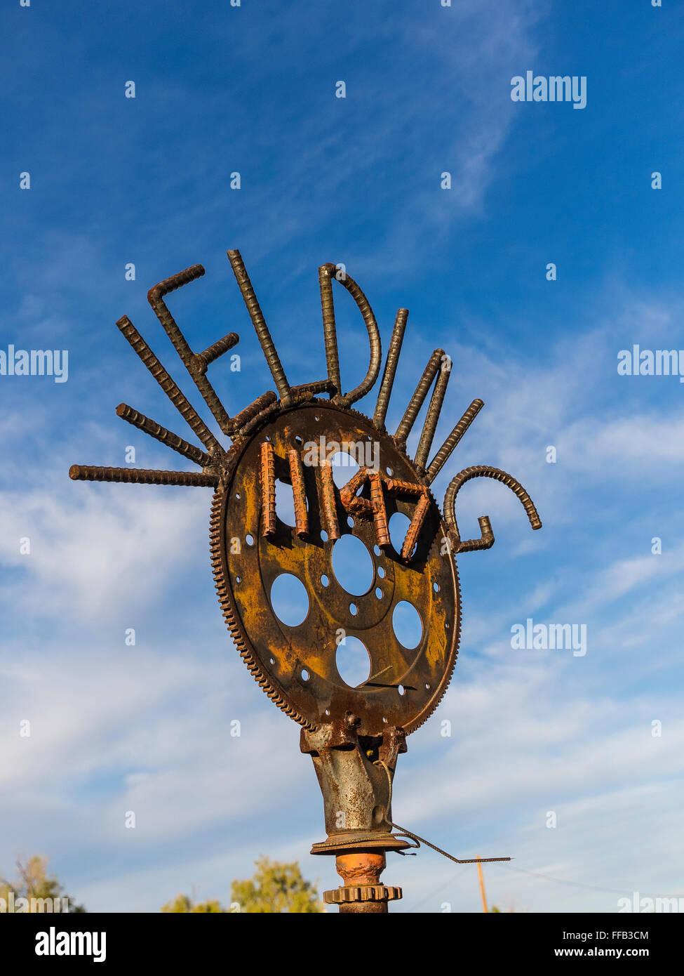 A clever metal welded sign with an address on it advertising a welder's shop in Morongo, California. Stock Photo