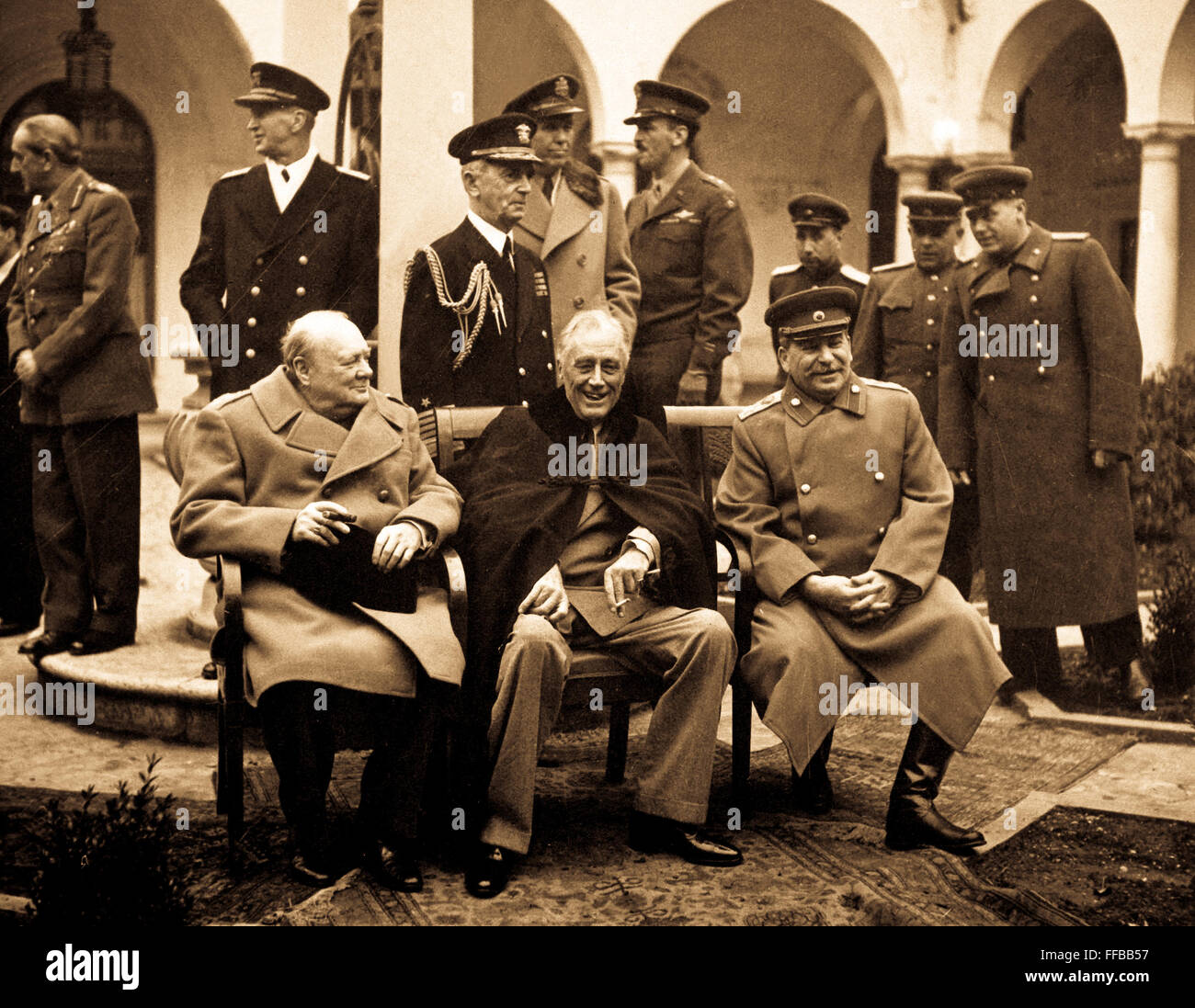 Conference of the Big Three at Yalta makes final plans for the defeat of Germany.  Here the 'Big Three' sit on the patio together, Prime Minister Winston S. Churchill, President Franklin D. Roosevelt, and Premier Josef Stalin.  February 1945. Stock Photo