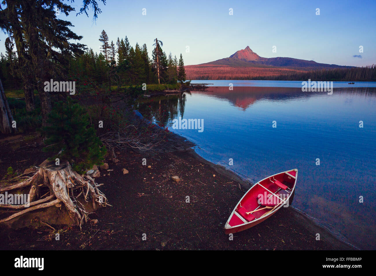 Big Lake with a canoe on the shore and Mt Washington in the background of this nature scenic. Stock Photo