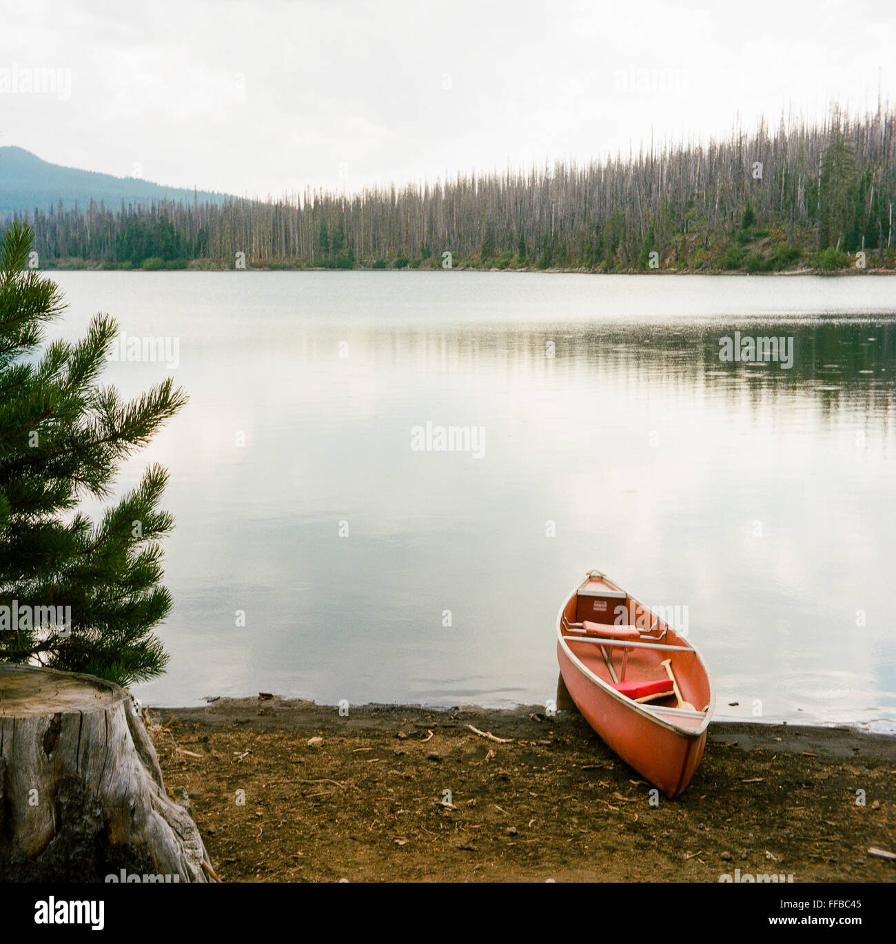 Canoe on the shore of Big Lake in Oregon located at the summit of Santiam Pass. Stock Photo