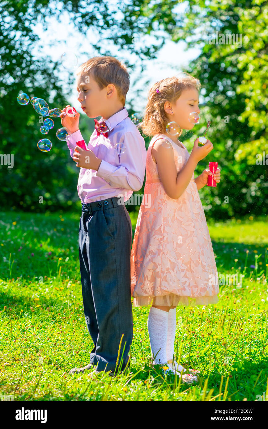 preschool age children with soap bubbles outdoors Stock Photo